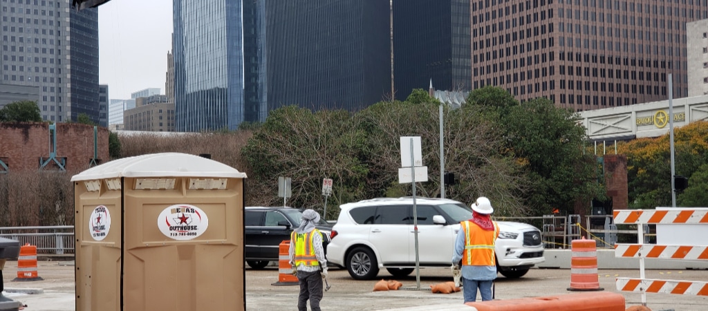 A bilingual construction foreman explaining details of project to a Spanish speaking employee in downtown, Houston, Texas.