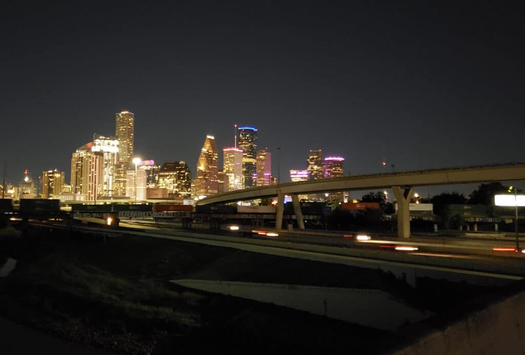 Houston skyline from I-45 near Hogan Street - Explore the role of translation services in major urban development projects.