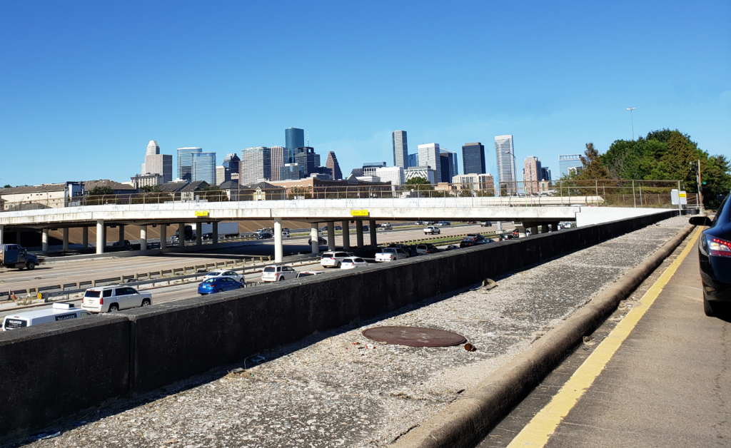 Houston's I-45 near Emancipation Park with city skyline - Discover the impact of infrastructure projects on local communities.